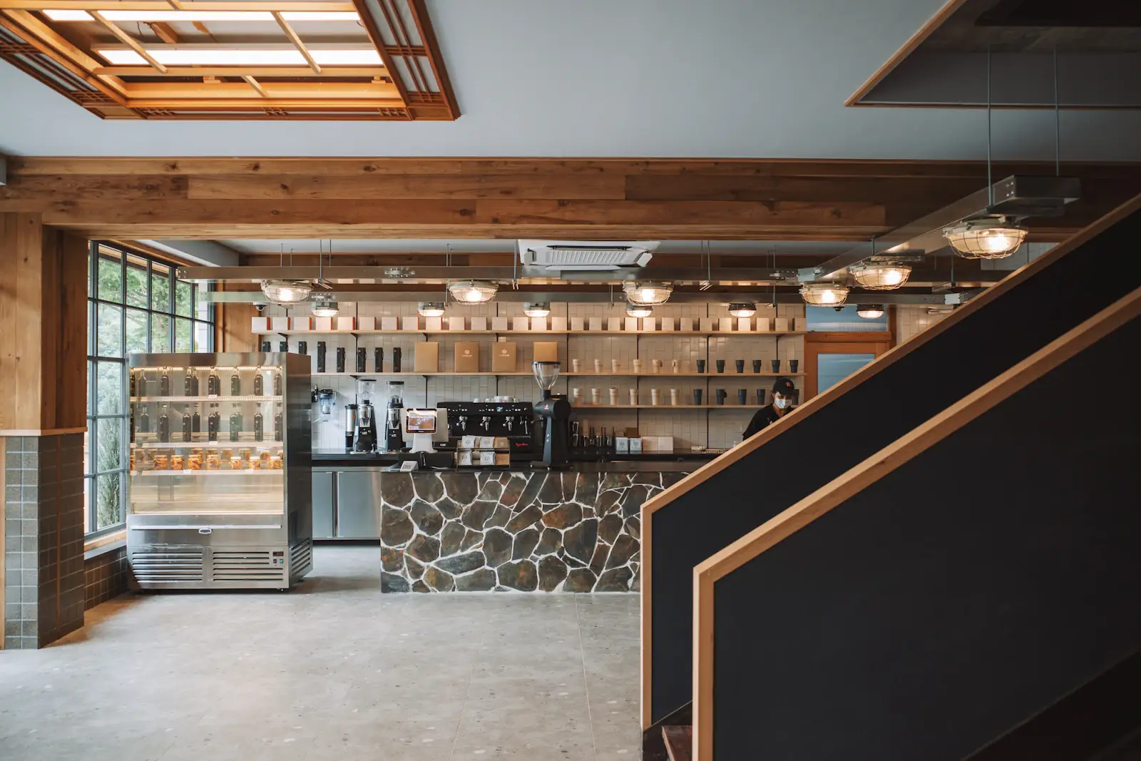 The café bar with wooden shelves and warm light